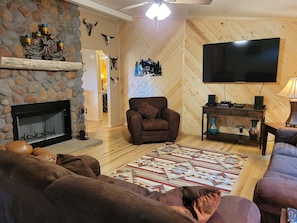 Living room with working fire place. TV has DISH.
