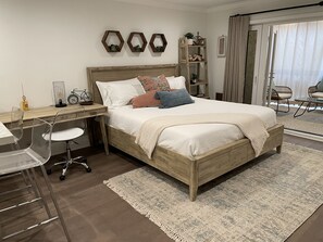 Bed, desk and kitchen counter area