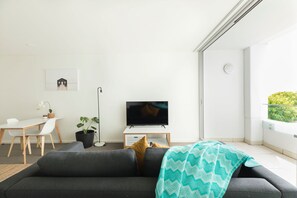 Open the sliding doors on the balcony to enjoy the fresh sea air.