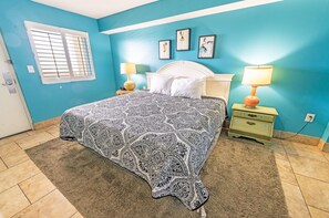 - Relax in this beautifully designed bedroom featuring a plush king sized bed - Cozy ambiance with warm lighting, soft linens, and charming bedside tables - Stylish coastal decor creates a peaceful retreat for a restful night’s sleep