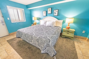 - Relax in this beautifully designed bedroom featuring a plush king sized bed - Cozy ambiance with warm lighting, soft linens, and charming bedside tables - Stylish coastal decor creates a peaceful retreat for a restful night’s sleep