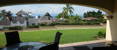 View from the living room looking through the outdoor patio toward the ocean.