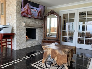 Living Room with functioning fireplace and large smart TV