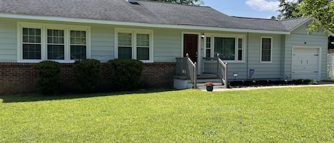 Front of the Cozy Ranch-porch light, solar pathway lights. Ring doorbell camera 