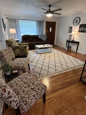 Living Room with HW Floors, area rug, seating for 6, end table, coffee table