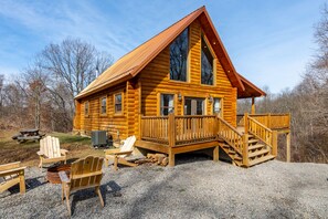 Outside the Madison with large wraparound deck, fire pit, and picnic table