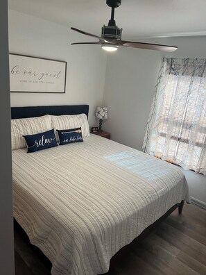 Primary bedroom with a king bed and45 inch smart tv