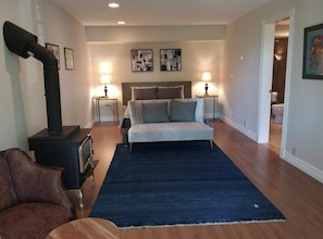 Bedroom with gas stove that mimic wood burning stove and in suite bathroom