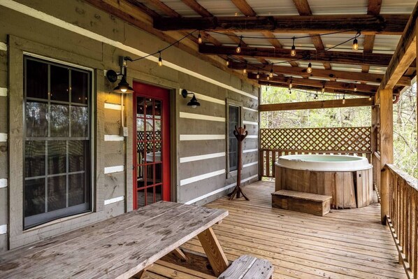Back side of porch with picnic table & hot tub