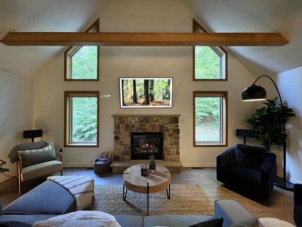 Living room seating area, Samsung frame tv, and gas fireplace