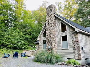 Front view of the home, with seating for four around a wood-burning firepit