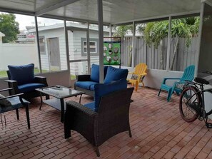 Patio, can see stadium.  TV and chairs.    Palm Trees and Xmas lights