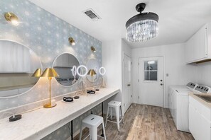 Makeup and laundry room with washer and dryer.