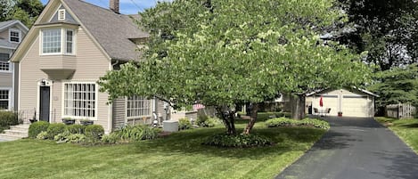 Front of house, with long driveway leading up to porch area (on side of house)