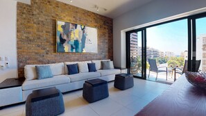 Spacious open floorplan with views to the balcony featuring city/ocean views
