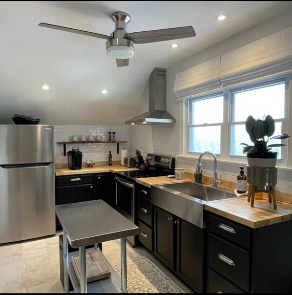 Fully stocked kitchen. Pots, pans, glassware, utensils and microwave. 