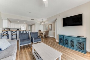 Living room looking into kitchen and dining area