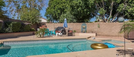 Large backyard area w/ patio seating, swimming pool and spa, and BBQ. Pool and spa heating optional,  fee required 