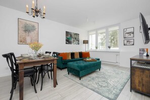 Relax in the stylish living room with a comfortable sofa and modern decor.