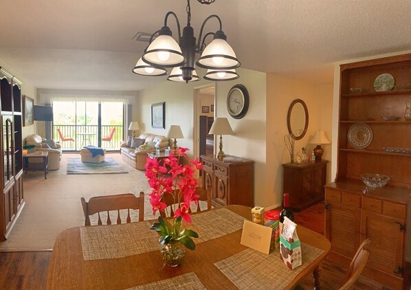 Wide shot of the spacious living room and dining area