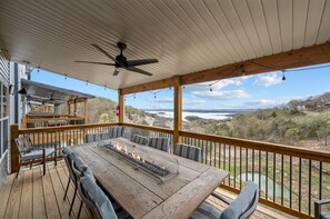 Large dining table with fire feature on the main level deck