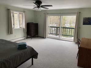 Master bedroom with King bed, desk &  direct access to deck overlooking the lake