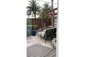 Front patio area,Neptune Avenue, Across from the palm trees is the ocean