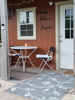 Front porch with bench, table and chairs, sit, have coffee, and watch the ducks.