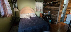 Queen size bed with cushion headboard, night stand and light.  