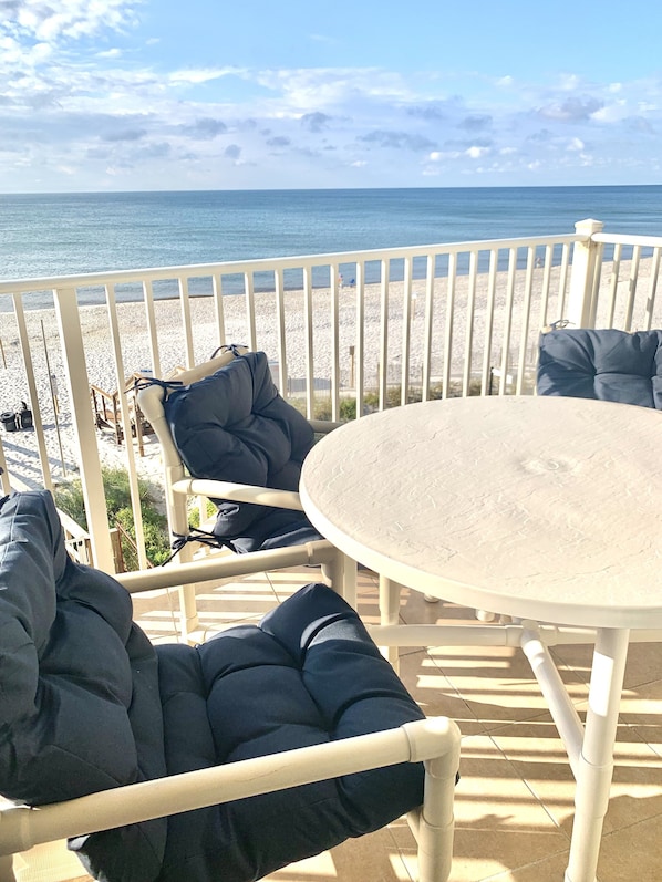 Private balcony with table and seating for four.