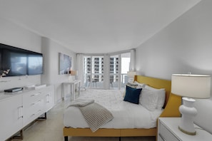 Master bedroom suite, vanity, king bed, Roku tv, desk, balcony access, bathroom