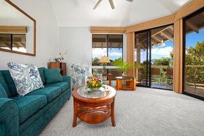 An airy, open-concept living room with plush seating and tropical decor invites relaxation GCH-134
