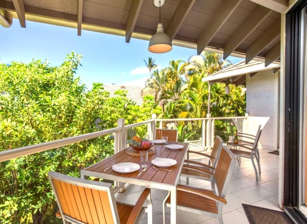 A spacious wrap-around lanai presents lush garden views and ample seating for outdoor relaxation GCH-134