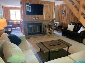 Comfortable living room; kitchen area past fireplace