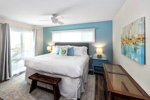 King bed with white linens.
