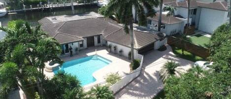 Aerial view of a waterfront home.
Private Heated Gated Swimming Pool
75ft Dock (boat/yacht pick allowed by approved vendors) 