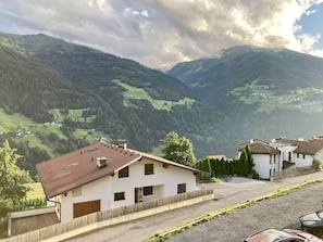Cloud, Sky, Plant, Mountain, Building, Window, Highland, Vehicle, Slope, House