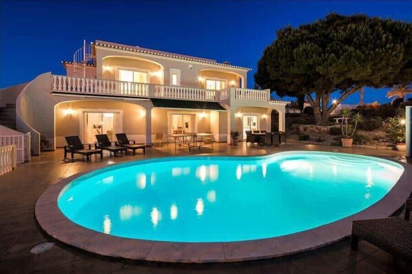 Pool and villa at night