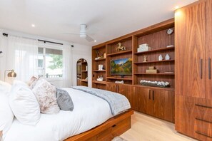 Primary Bedroom featuring King Bed with Plush Mattress and Custom Walnut Built-ins