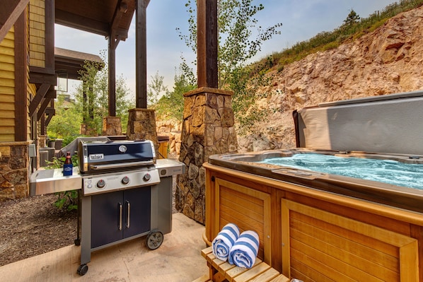 Private Hot Tub patio with seating and table for two, propane bbq, and 8-person spa