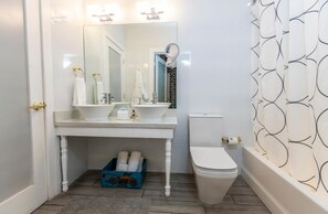 Bathroom with a shower and tub. The essential toiletries and towels are provided