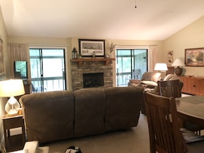 Large living room with rock gas fireplace.  Two sliding doors to screen porch. 