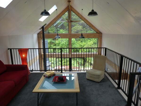 Mezzanine living space looking into bush and over void