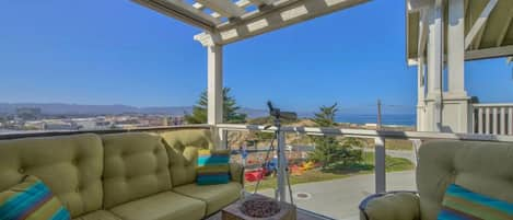 Upstairs balcony with ocean view…cozy up next to the Firepit!