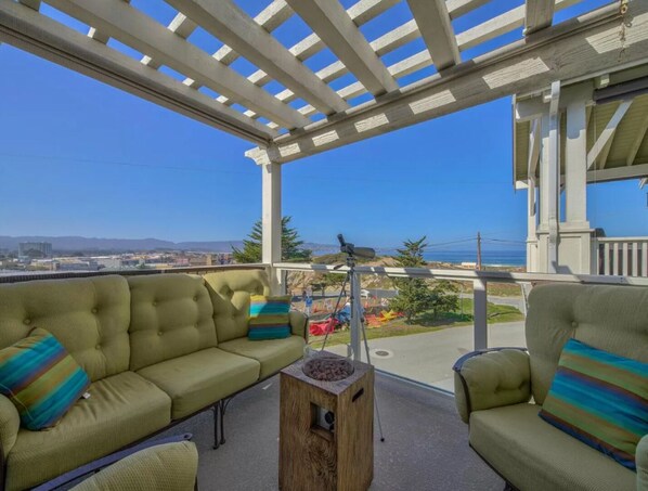 Upstairs balcony with ocean view…cozy up next to the Firepit!