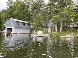 View from the water of Blue Skies Cottage’s Dock & the Boathouse.