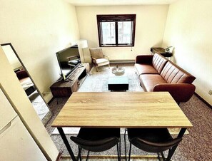 Living room with dining table from kitchen view