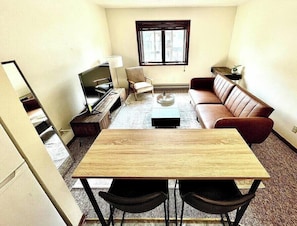 Living room with dining table from kitchen view