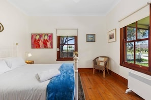 The two bedrooms feature antique wrought-iron Queen size beds in spacious surrounds, with the master enjoying views across the veranda to the setting sun. True to its name, this is Sunset Cottage. 