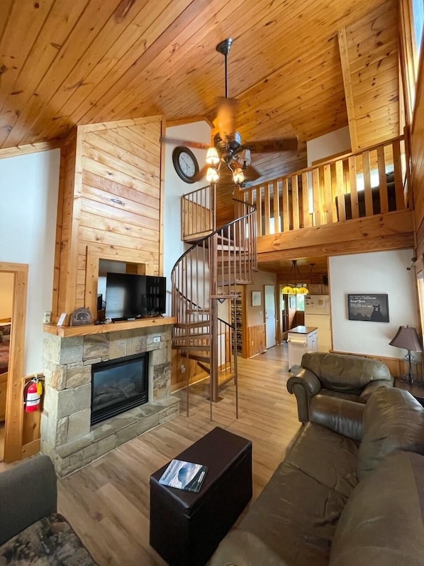 Main level living room with fireplace and tv